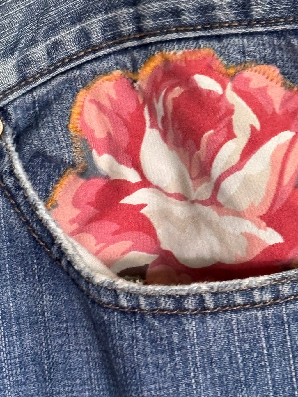 Floral fabric patch on a denim background