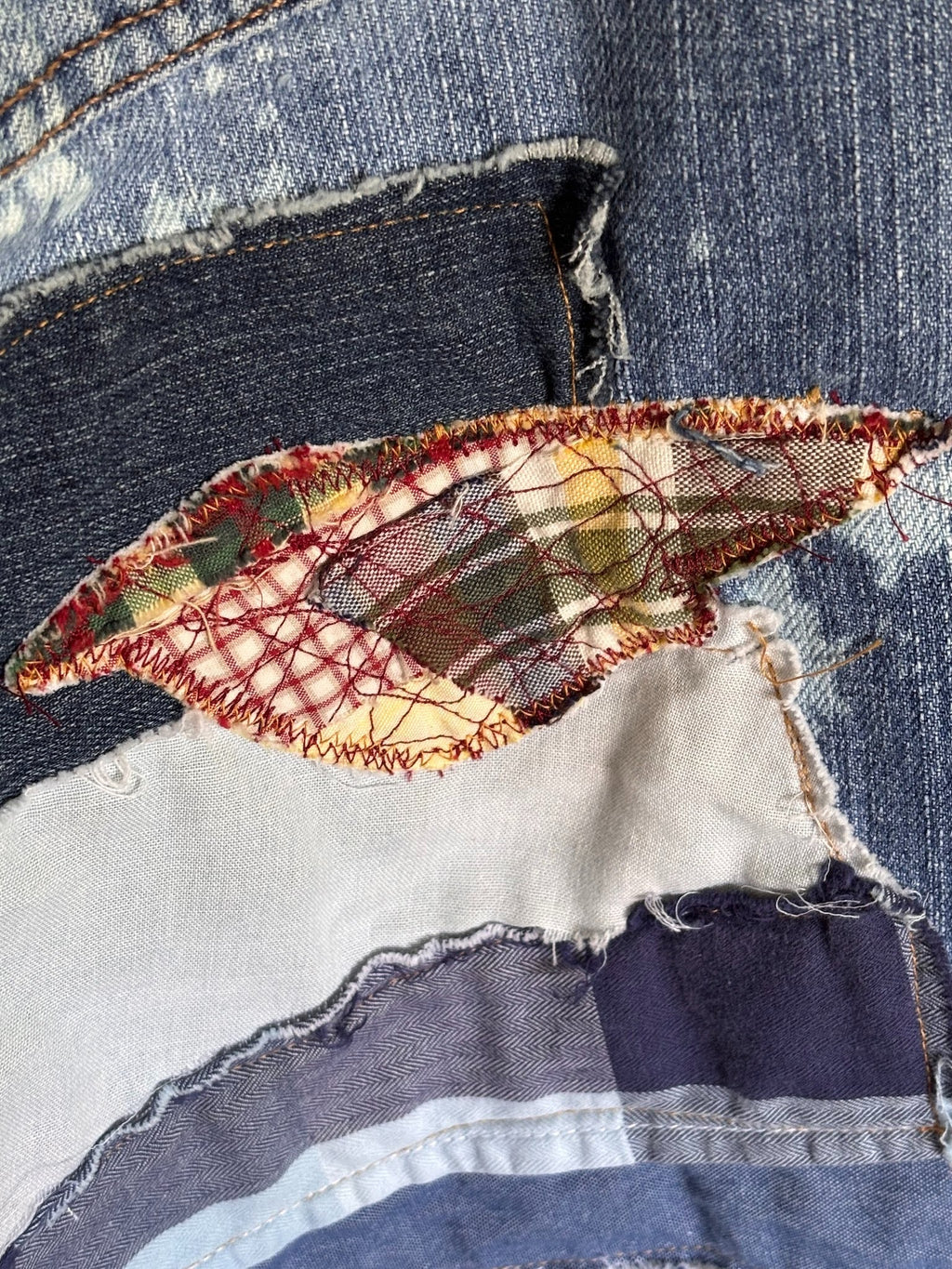 sewn patchwork on denim jeans